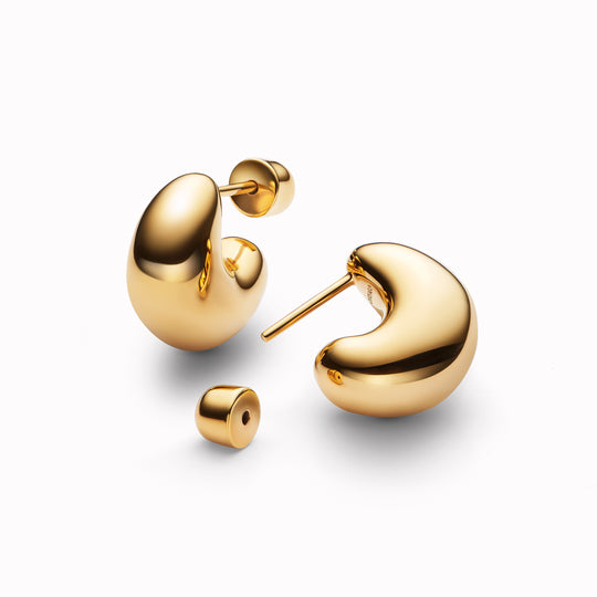 The Tryvann Pillow earring is designed in Denmark and skilfully crafted in 925 recycled sterling silver and plated with either White Rhodium or 18ct Gold, It is a chunky half-hoop earring that is Nickel free and hypoallergenic.
