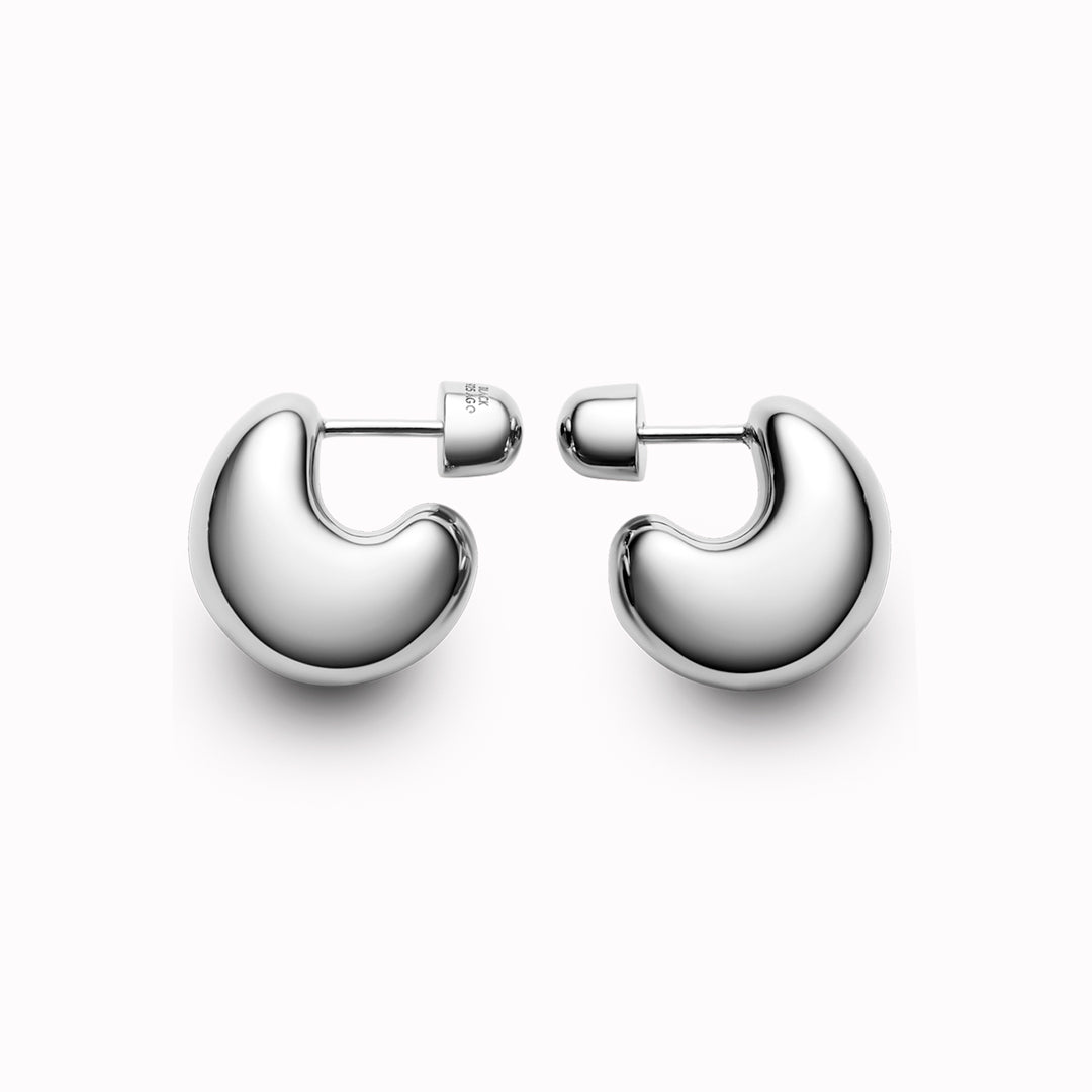 The Tryvann Pillow earring is designed in Denmark and skilfully crafted in 925 recycled sterling silver and plated with either White Rhodium or 18ct Gold, It is a chunky half-hoop earring that is Nickel free and hypoallergenic.