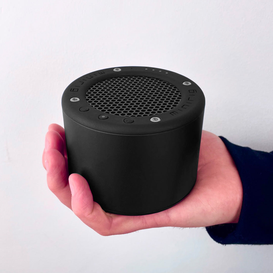 In Hand - The Minirig Mini 4 in Ultra Black is a portable Bluetooth speaker that represents the latest innovation in audio technology. Crafted in Bristol, UK, this speaker is the result of over a decade of design evolution, offering a robust anodized aluminium and high-impact ABS construction.