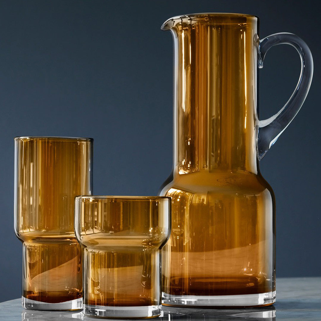 Collection - The Utility Jugs and Tumblers are a hand made product and features a hand applied handle and hand formed spout. The edge is melted to achieve a thick soft rim and the spout is shaped by hand using a wooden tool. The handle is gathered from molten glass and applied while the glass is still malleable.