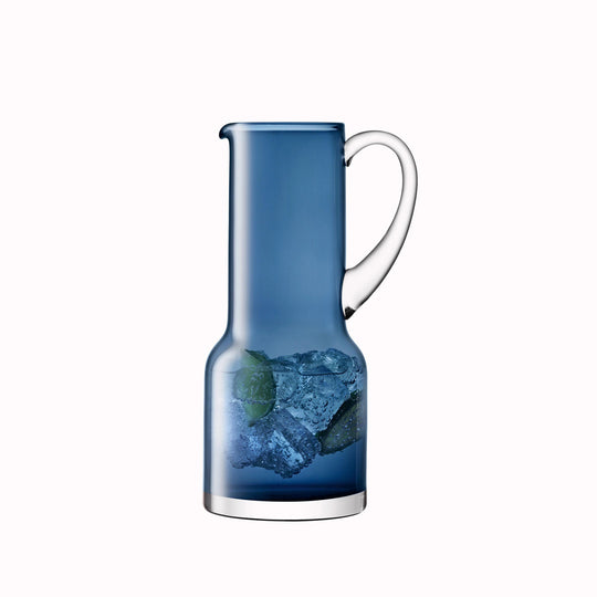 The Utility Jug is a modern, step shaped mouth-blown table jug made from Sapphire Blue coloured glass by LSA International. 