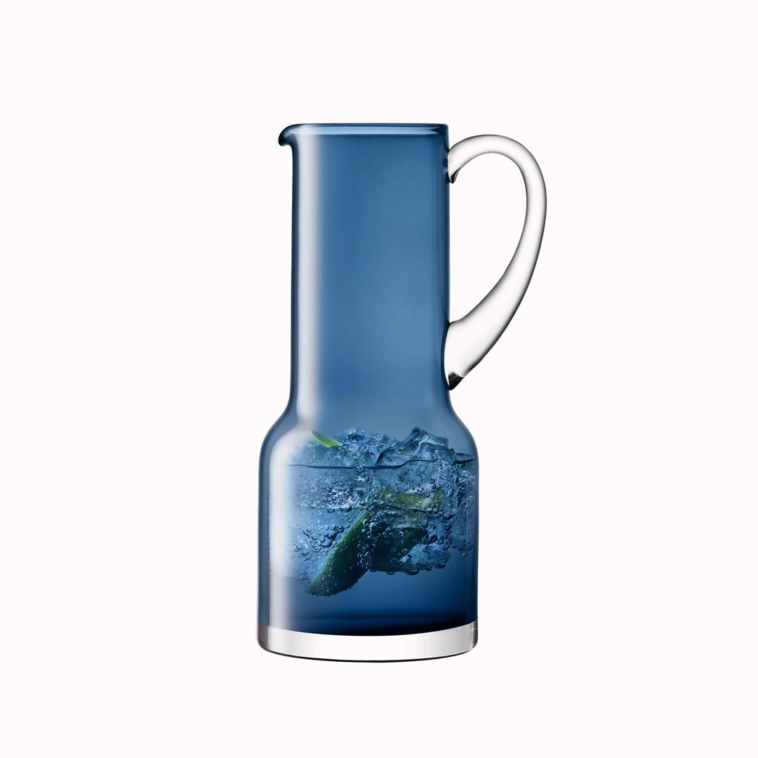 The Utility Jug is a modern, step shaped mouth-blown table jug made from Sapphire Blue coloured glass by LSA International. 