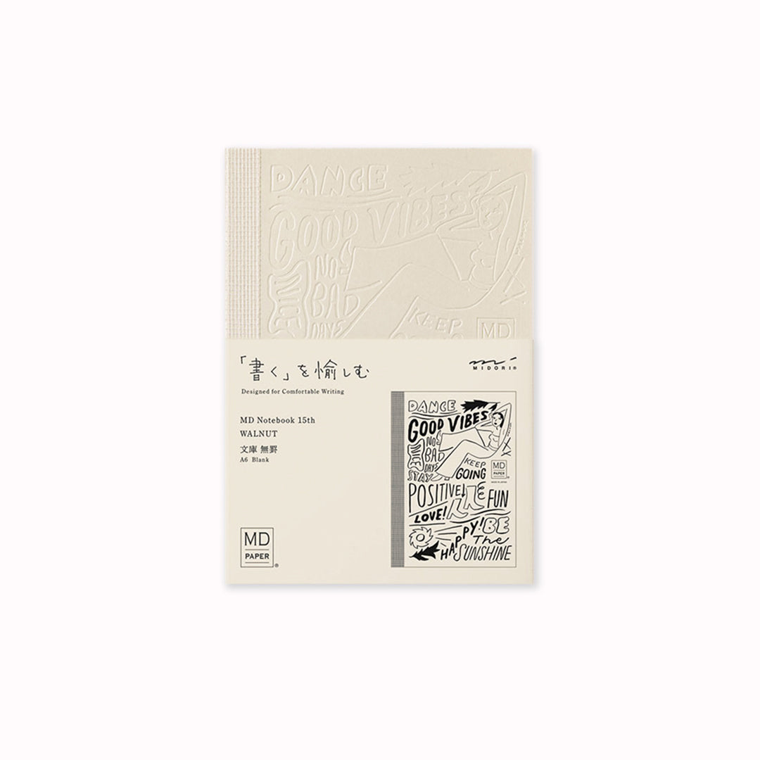 This A6 plain paper notebook has an off white cover embossed with some ace artwork by WALNUT featuring a female figure lounging amid positive quotes such as 'Be The Sunshine'.  The MD paper logo is also emboss