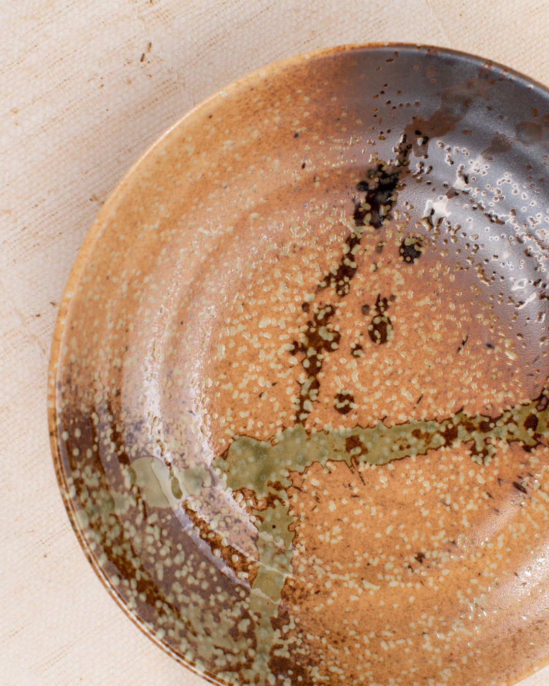 Shallow noodle bowl featuring a rustic glaze with striking green splash. Diameter 225mm and height approx 50mm.