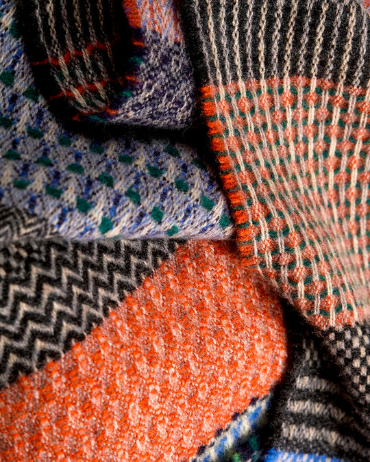 The Walton scarf is an artful mixture of textures and pattern, where graphic dots, dashes, and zigzags interplay. This is all emphasised by colour and contrast.