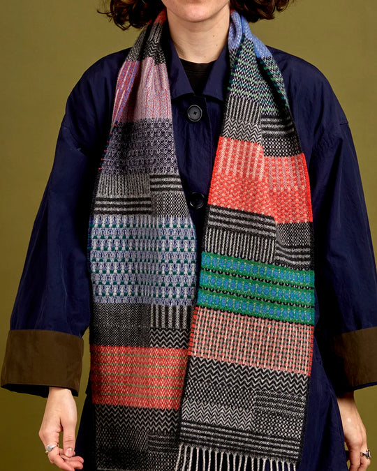 The Walton scarf is an artful mixture of textures and pattern, where graphic dots, dashes, and zigzags interplay. This is all emphasised by colour and contrast.
