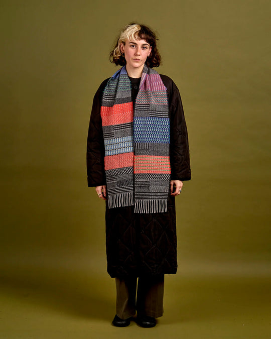 The Walton scarf is an artful mixture of textures and pattern, where graphic dots, dashes, and zigzags interplay. This is all emphasised by colour and contrast.