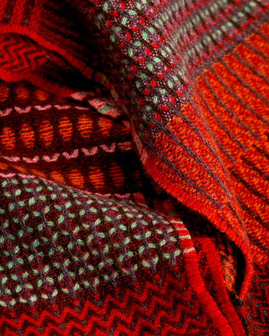 The Walton scarf is an artful mixture of textures and pattern, where graphic dots, dashes, and zigzags interplay. This is all emphasised by colour and contrast.