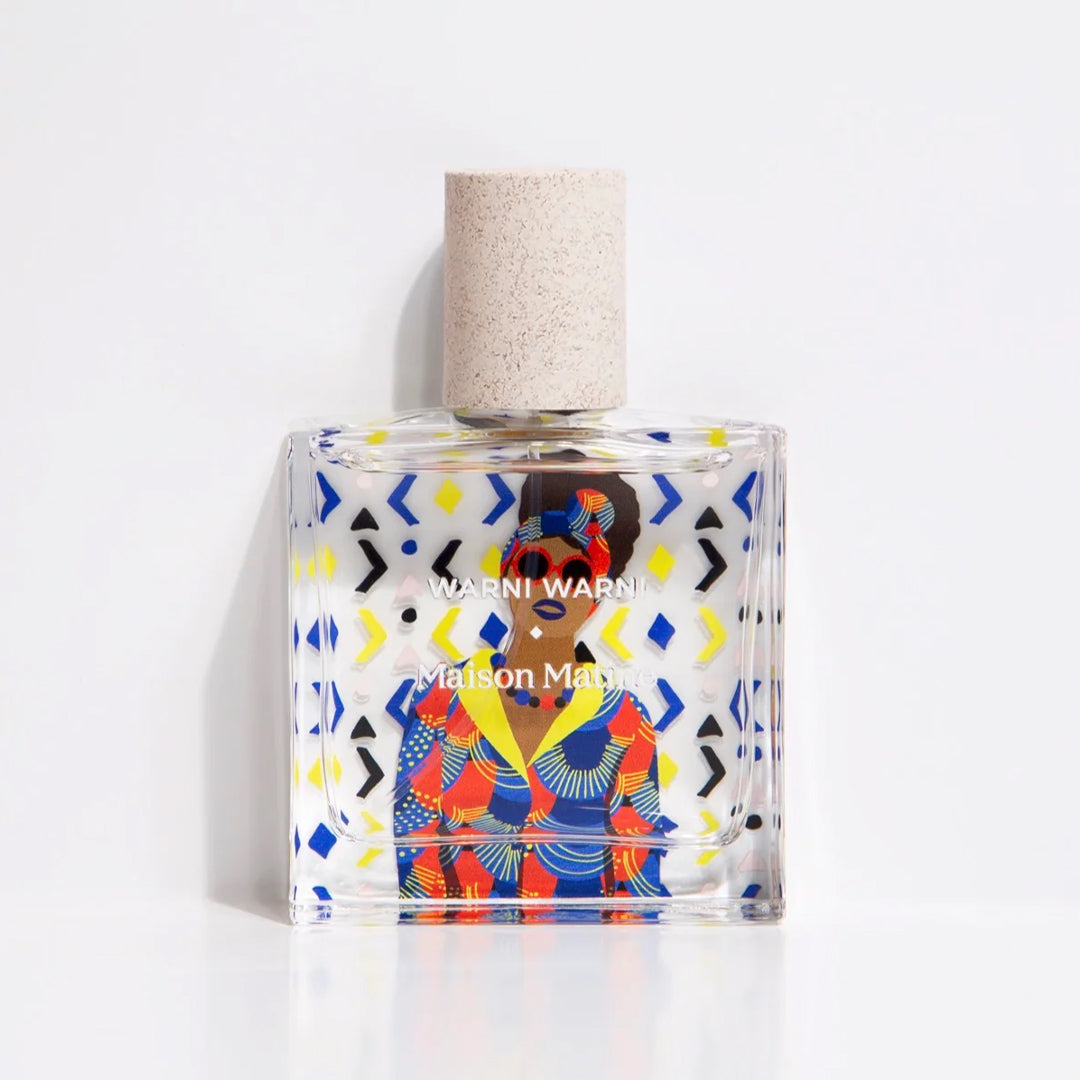 Maison Matine's 'Warni Warni' is a scent inspired by a sharing, welcoming diversity and cultural mixing, all housed in an illustrative glass bottle. The name means 'come to me' which is an invitation to share in Arabic. Patterned 50ml bottle with woman in sunglasses.