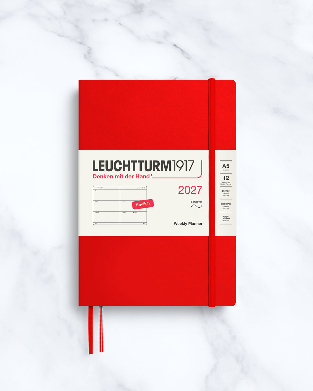This A5 softcover yearly planner showcases 12 months of weekly layouts, including phases of the moon and international holidays.