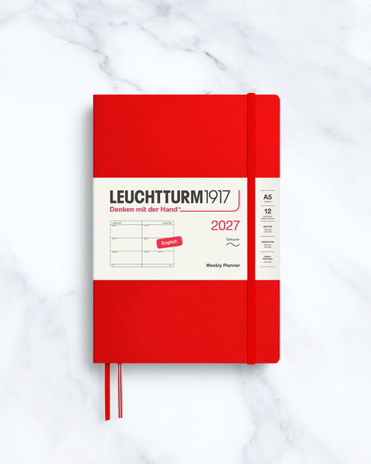This A5 softcover yearly planner showcases 12 months of weekly layouts, including phases of the moon and international holidays.