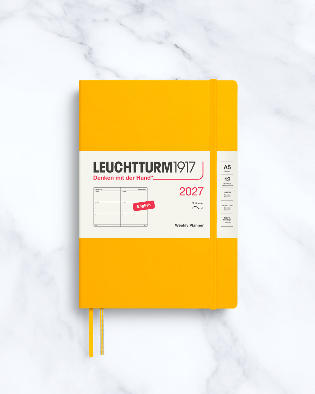 This A5 softcover yearly planner showcases 12 months of weekly layouts, including phases of the moon and international holidays.