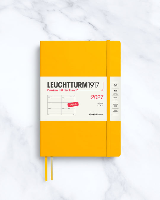 This A5 softcover yearly planner showcases 12 months of weekly layouts, including phases of the moon and international holidays.