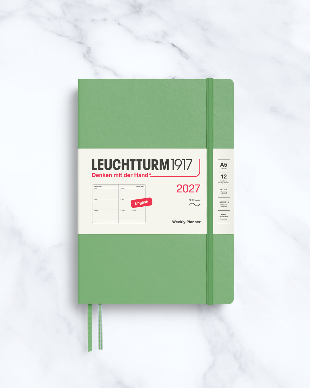 This A5 softcover yearly planner showcases 12 months of weekly layouts, including phases of the moon and international holidays.