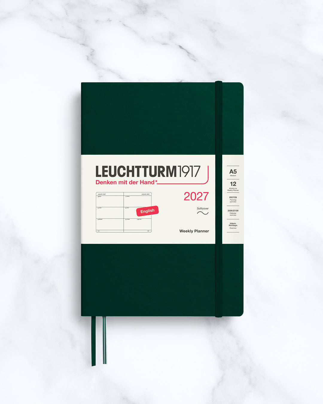 This A5 softcover yearly planner showcases 12 months of weekly layouts, including phases of the moon and international holidays.