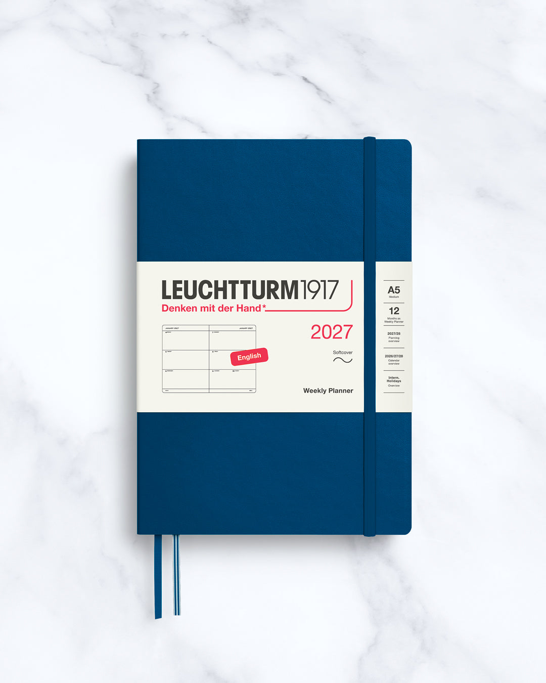 This A5 softcover yearly planner showcases 12 months of weekly layouts, including phases of the moon and international holidays.