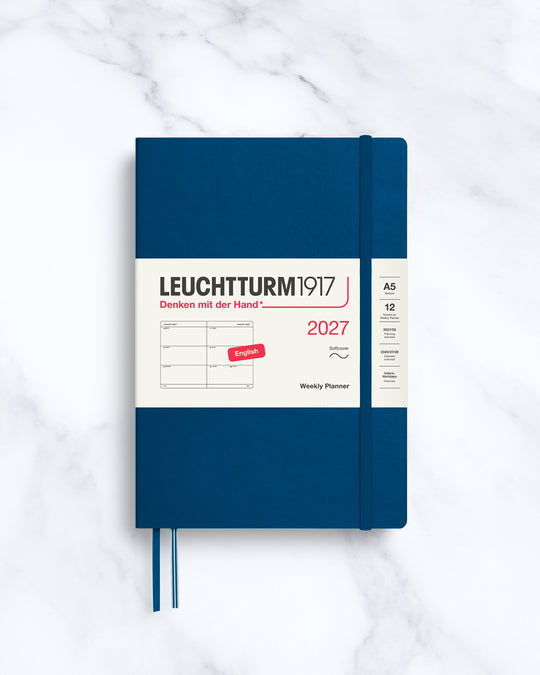 This A5 softcover yearly planner showcases 12 months of weekly layouts, including phases of the moon and international holidays.