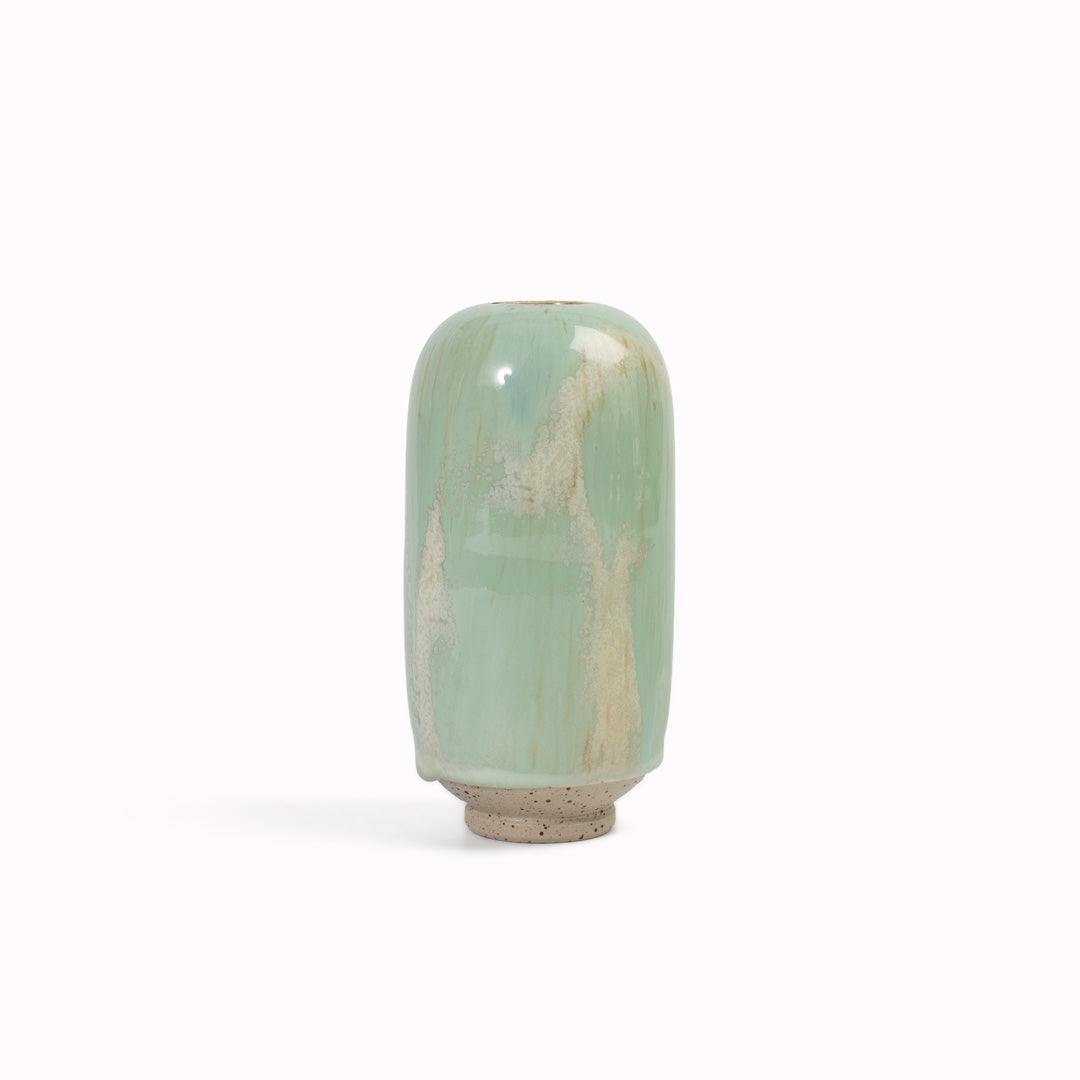 hand-thrown in watertight stoneware. Due to the rounded taper at the top of the vase, the glaze melts down the sides of the cylindrical vase mimicking melting ice.&nbsp;