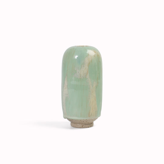 hand-thrown in watertight stoneware. Due to the rounded taper at the top of the vase, the glaze melts down the sides of the cylindrical vase mimicking melting ice.&nbsp;