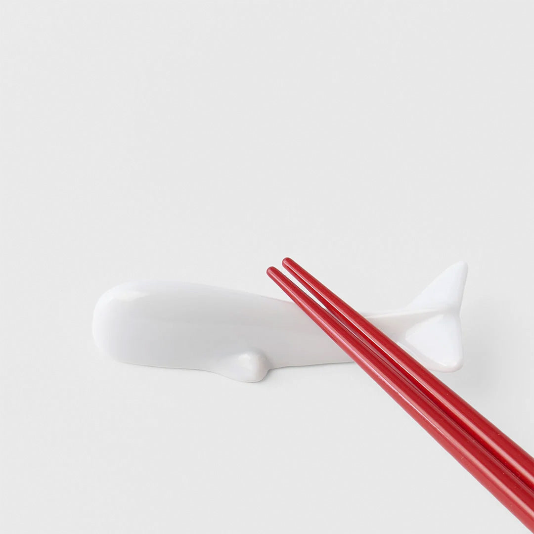 A pure white porcelain whale chopstick rest. 8.5cm x 3cm 1.5cm height Made of 'Minoyaki' porcelain, fired at a high temperature and hand finished in Gifu prefecture, Japan. Detail with Chopsticks