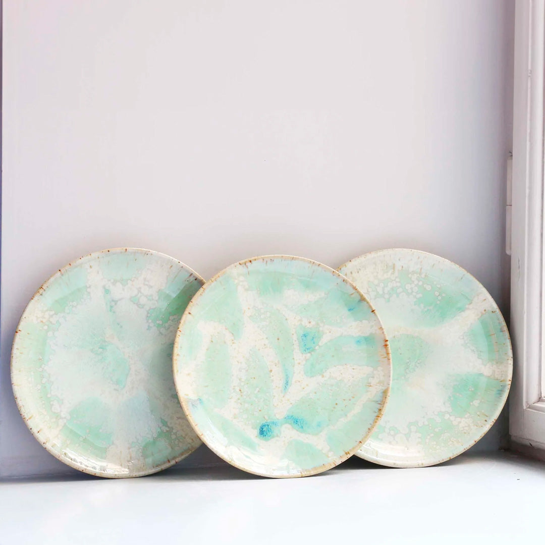 The Whispy Mint Crystal Moon Plate from Studio Arhoj is hand thrown and hand glazed in Copenhagen