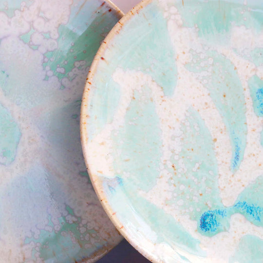 The Whispy Mint Crystal Moon Plate from Studio Arhoj is hand thrown and hand glazed in Copenhagen