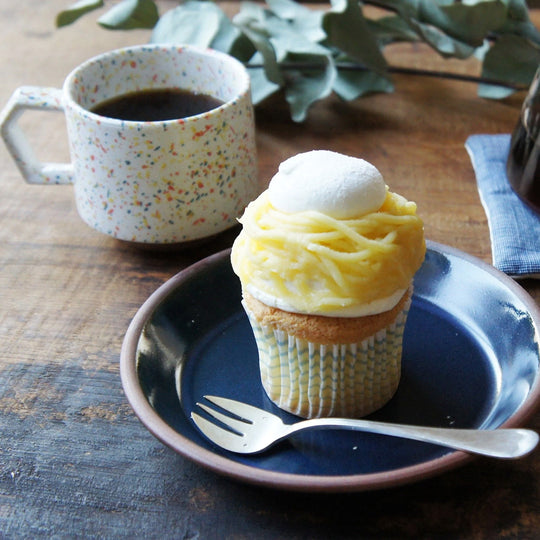 Compact and Easy to hold and stackable for easy storage. This Splash mug has a mixture of orange, yellow, and blue onto a white base with an unglazed base. They are sturdy and comfortable to hold with a unique silhouette.