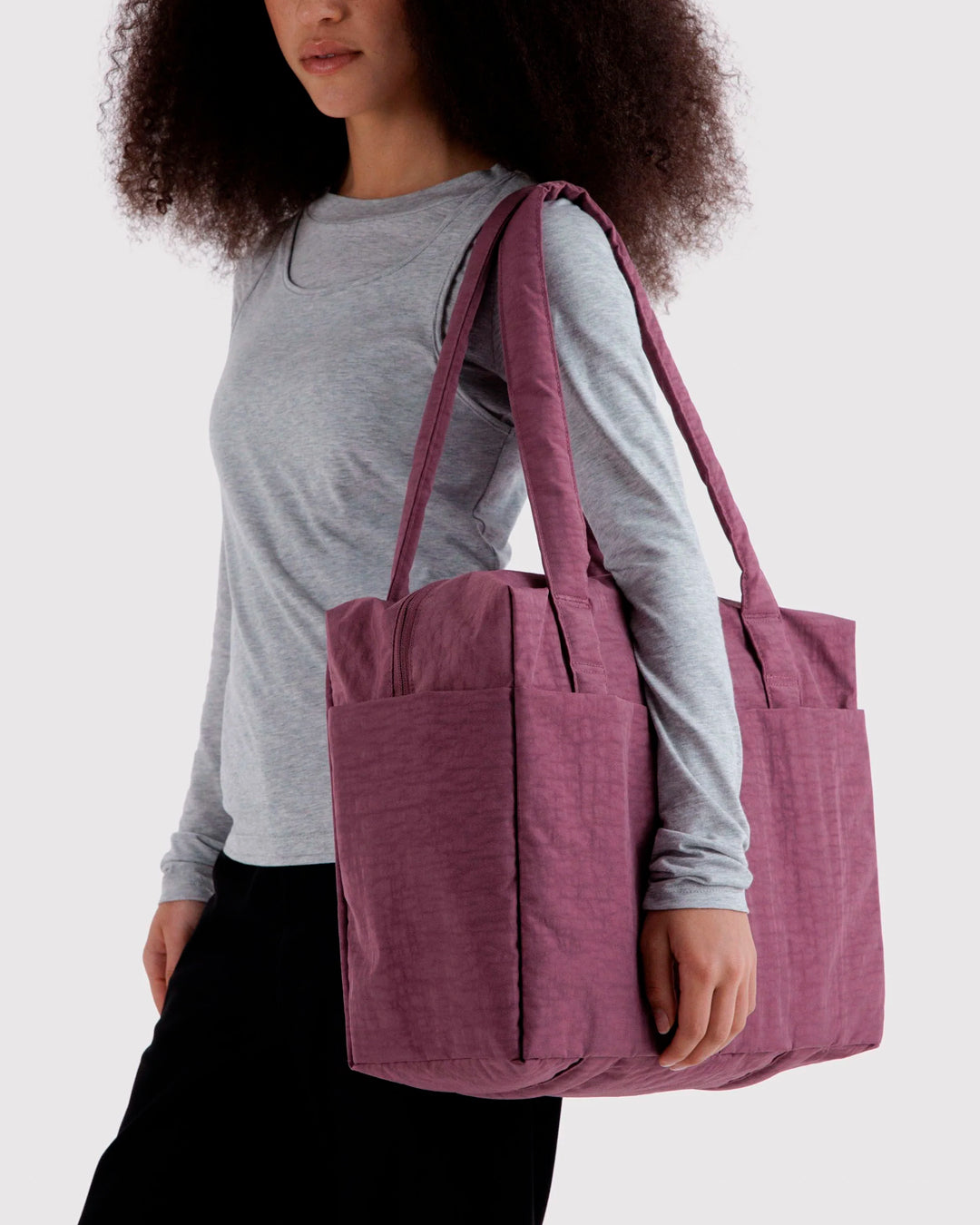 A compact carry-on built around movement. This scaled-down version of BAGGU’s Cloud series keeps the same soft structure, but tightens the proportions for under-seat travel and everyday carry.