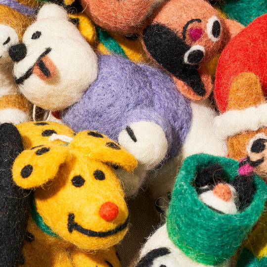 Cute, cuddly, and Christmassy - Toots the dog with a winter jacket on! A playful felted Christmas tree decoration designed by Cari Vander Yacht.