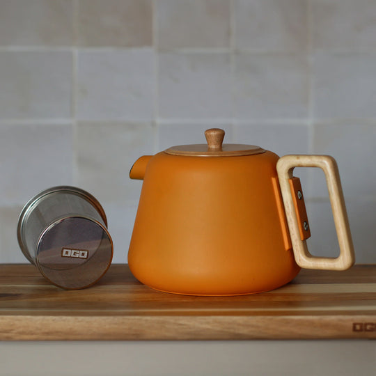 500ml cast iron tea pot with modern styling including almond green matte finish with a wooden handle and lid.