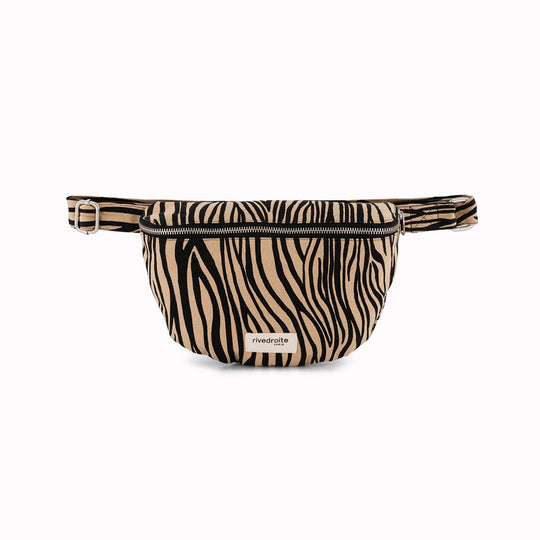 The Custine Belt Bag in Zebra Print is a stylish and practical accessory crafted from upcycled fabric. Designed by Rive Droite, a brand known for its commitment to sustainable fashion