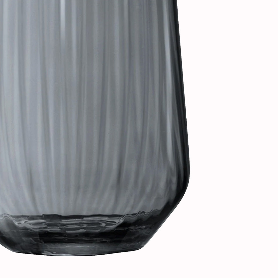 Detail of the Zinc Vase. The Zinc Vase is a teardrop shaped vase made from mouth blown glass and has a pleated texture with a hand painted lustre finish. The pleated texture enhances the grey colouration that is inspired by the colour of zinc.