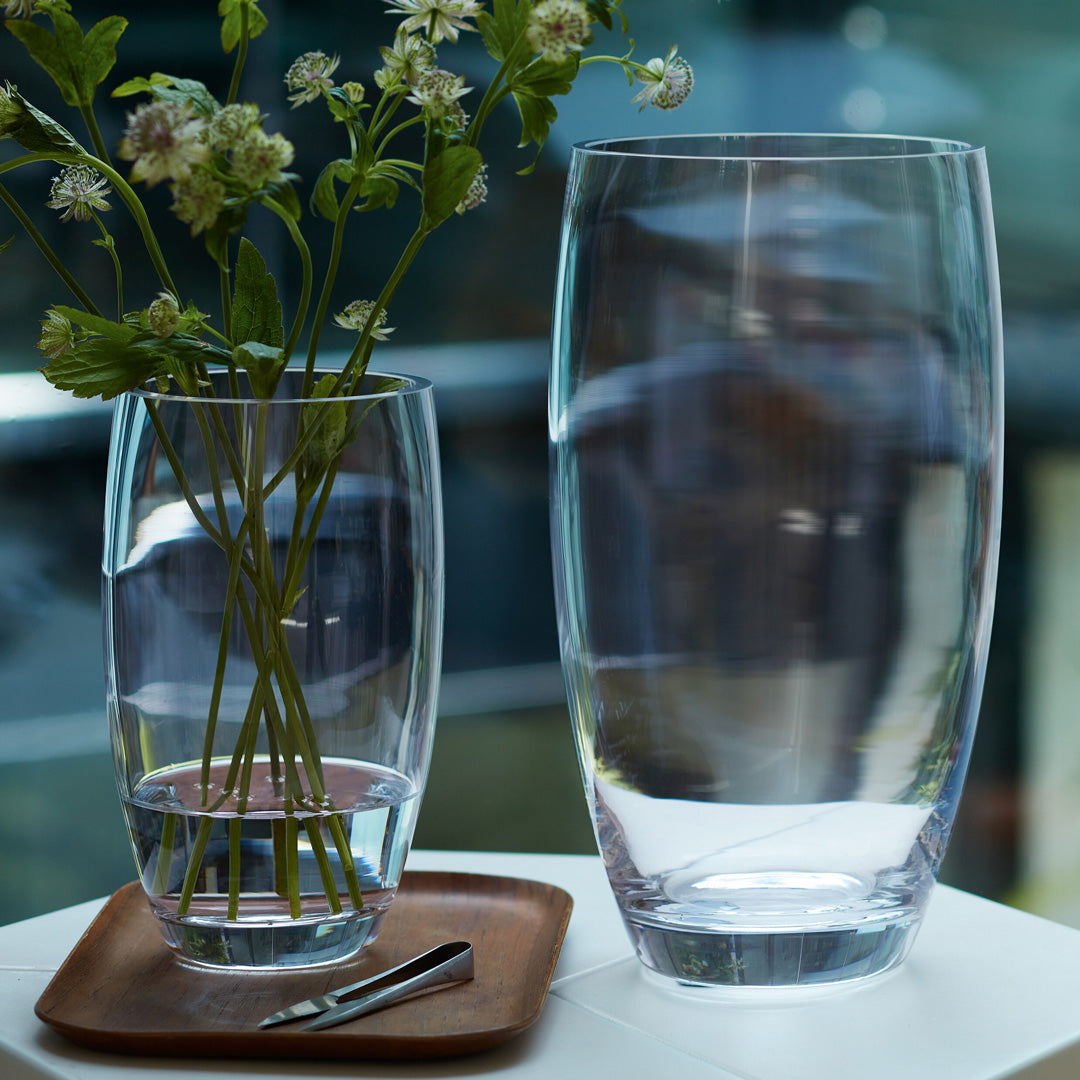 Collection - The Barrel Vase is a versatile, slender barrel shaped vase made from clear mouth blown glass. The Barrel Vase features a heavy base, thick walls and cut and polished rims with all finishing done by hand. 