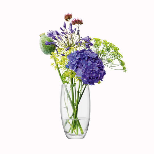 The Barrel Vase is a versatile, slender barrel shaped vase made from clear mouth blown glass. The Barrel Vase features a heavy base, thick walls and cut and polished rims with all finishing done by hand. 