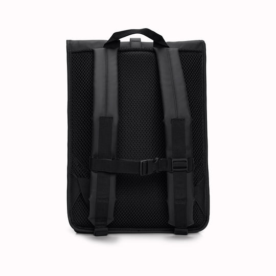 Rear View of Black Rolltop Rucksack. Made from Rains’ signature waterproof fabric, this functional backpack has a roll-top closure with an adjustable strap featuring a loop for a bike lock or similar. It has a large main compartment, and an easy-access front pocket and side-access laptop compartment both with a water-repellent zipper closure. 