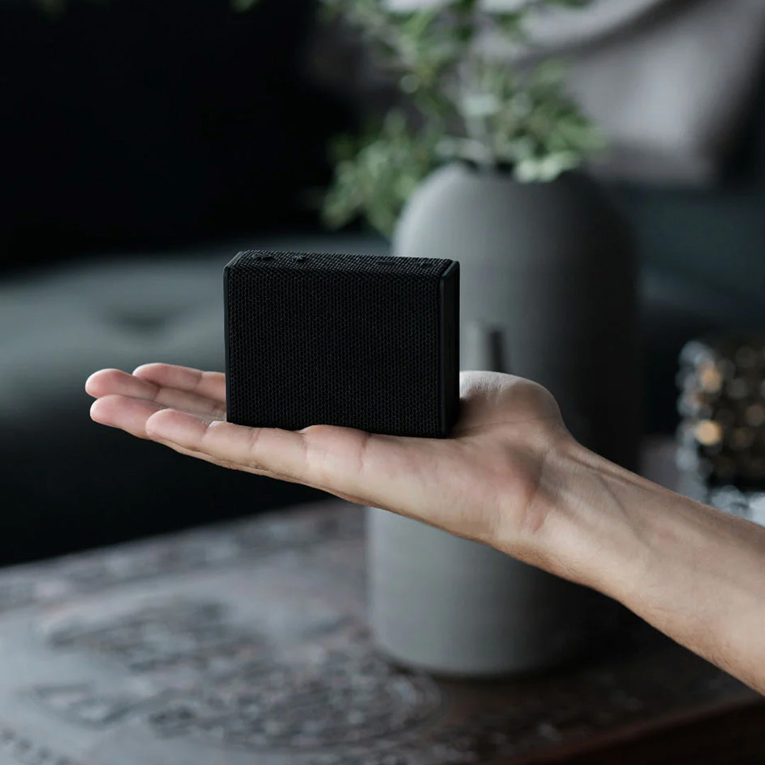 Lifestyle in Hand, Midnight Black Bluetooth travel speaker from Urbanista. Like all Urbanista products it has a stripped back and minimal aesthetic so perfect for the style conscious.