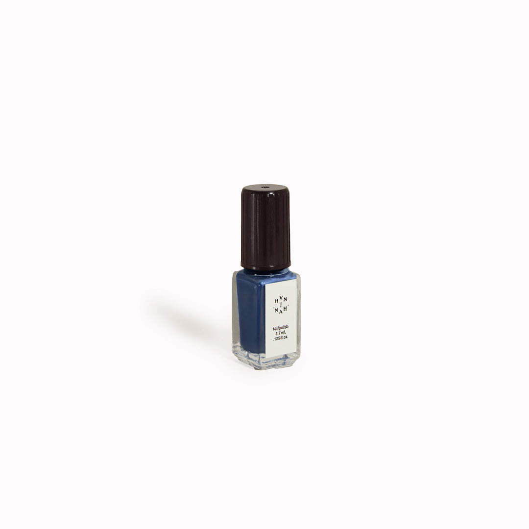 Blue Nudes, Mini Bottle from The Rarities Mini Nail Polish Set by J.Hannah. Includes five of their richest colour shades in petite bottles: Compost, Blue Nudes, Carob, Eames, and Ghost Ranch. Packaged in a reusable mesh zipper pouch, the Rarities Mini Polish Set is designed for gifting and travel.