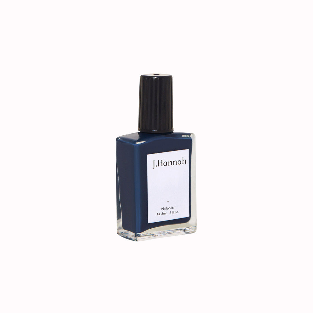 Angled view of Blue Nudes nail polish by J.Hannah is a rich midnight inky blue, inspired by the works of Henri Matisse.