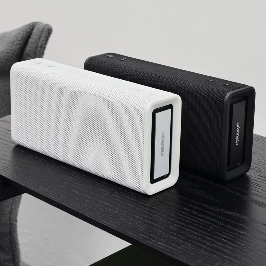 Black and White Mist Bluetooth travel speaker from Urbanista Collection on table. Like all Urbanista products it has a stripped back and minimal aesthetic so perfect for the style conscious.