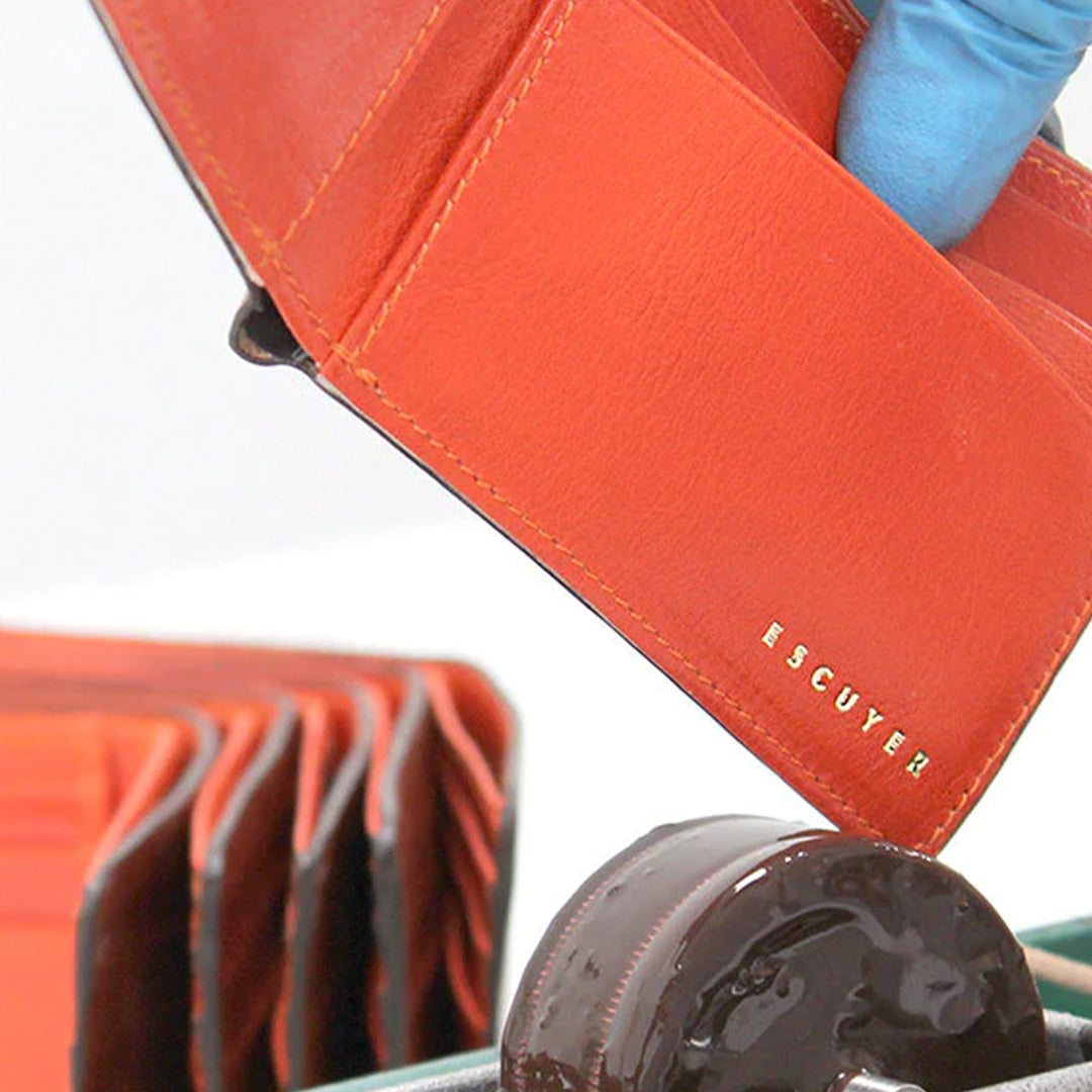 Manufacture Detail for Classic Cognac and Orange leather wallet from Escuyer, featuring a rich brown toned leather on the outside, with orange leather interior.