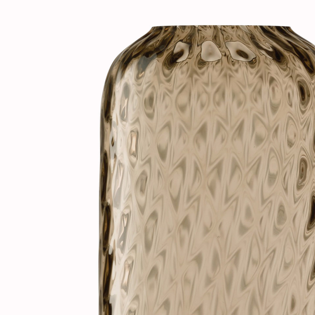 Detail of Earth Brown - Dapple Vase is a contemporary, tall and slim shaped vase made from coloured brown mouth blown glass. The Dapple Vase features a beautiful undulating textured surface that is inspired by dappled sunlight on water.