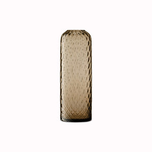 Earth Brown - Dapple Vase is a contemporary, tall and slim shaped vase made from coloured brown mouth blown glass. The Dapple Vase features a beautiful undulating textured surface that is inspired by dappled sunlight on water.