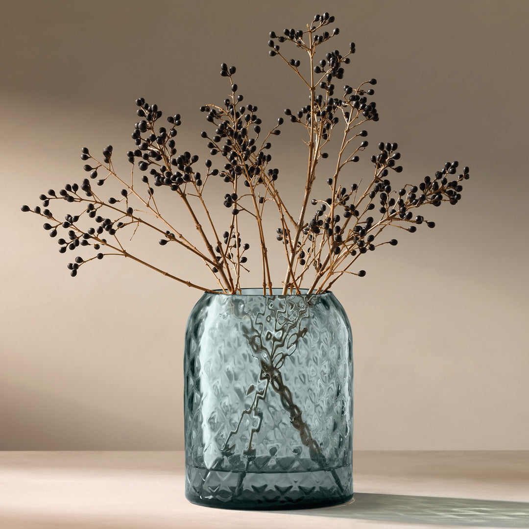 Dapple - Water Blue Vase. This medium sized vase is perfect for floral arrangements but can equally be used as candle lantern where the textured surface creates a patterned glow in a room.