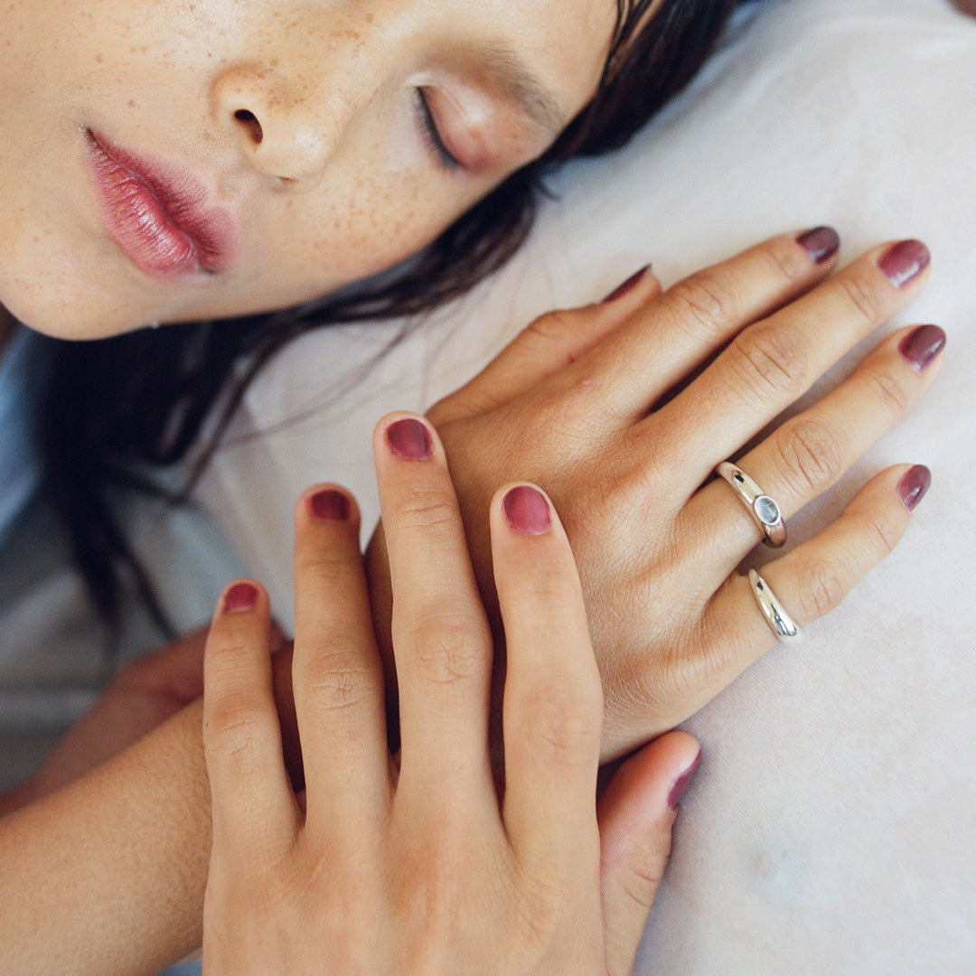 As Worn by model, Gamay nail polish by J.Hannah is a tinted red wine colour, inspired by the sheer shades of watercolours and wine stained teeth. An amethyst shade that deepens with multiple layers.