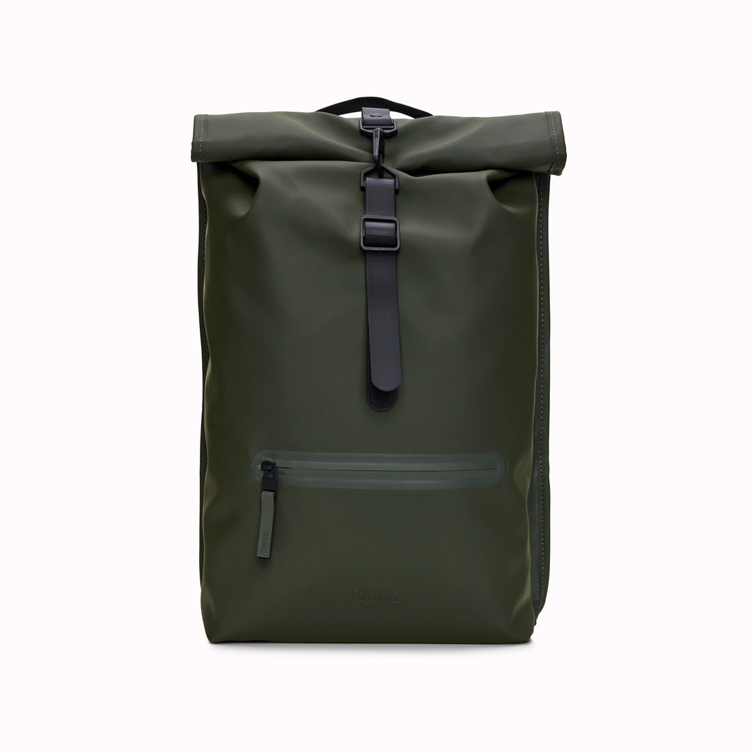 Front View of Green Rolltop Rucksack. Made from Rains’ signature waterproof fabric, this functional backpack has a roll-top closure with an adjustable strap featuring a loop for a bike lock or similar. It has a large main compartment, and an easy-access front pocket and side-access laptop compartment both with a water-repellent zipper closure. 