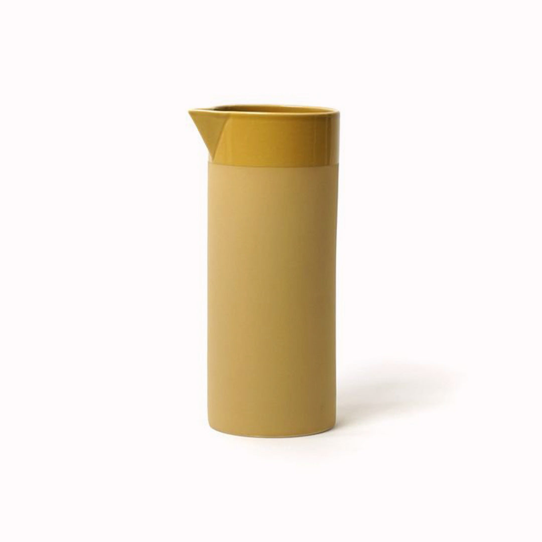Mustard Stoneware water jug from Dutch company Kinta who produce contemporary ceramics and homeware. The water jug has a matt mustard yellow glaze, with a gloss glaze lip and interior. Its simple cylindrical design is gives subtle colour to a contemporary table setting.