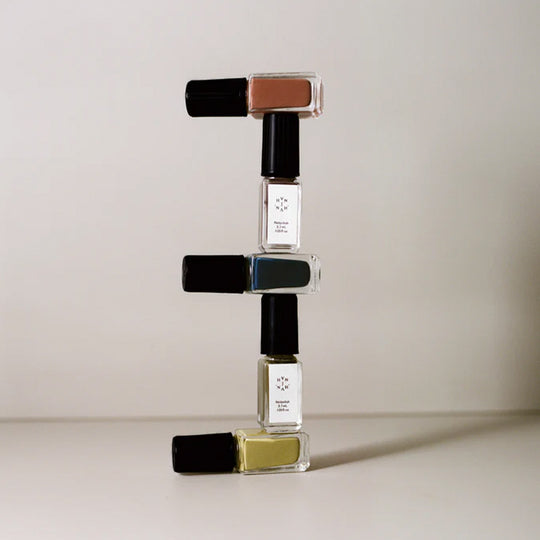Mini Bottle Stack from The Rarities Mini Nail Polish Set by J.Hannah. Includes five of their richest colour shades in petite bottles: Compost, Blue Nudes, Carob, Eames, and Ghost Ranch. Packaged in a reusable mesh zipper pouch, the Rarities Mini Polish Set is designed for gifting and travel.