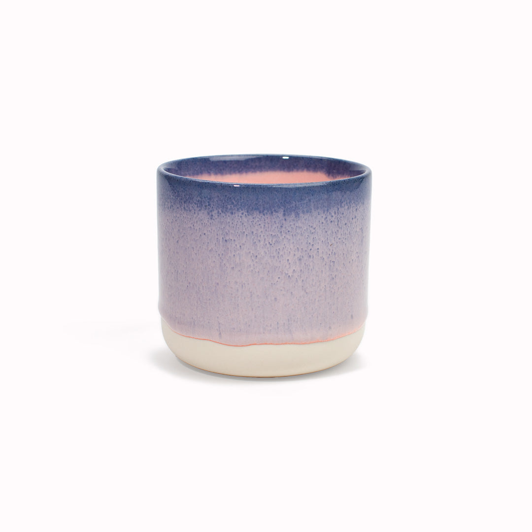 The blue rimmed, mainly pink mug is handmade in Denmark - meaning glaze colour and finish will never be exactly the same on any two items, but this is absolutely a part of their unique appeal.