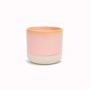The yellow rimmed, pink drip glazed Quench Cup is handmade in Denmark - meaning glaze colour and finish will never be exactly the same on any two items, but this is absolutely a part of their unique appeal.