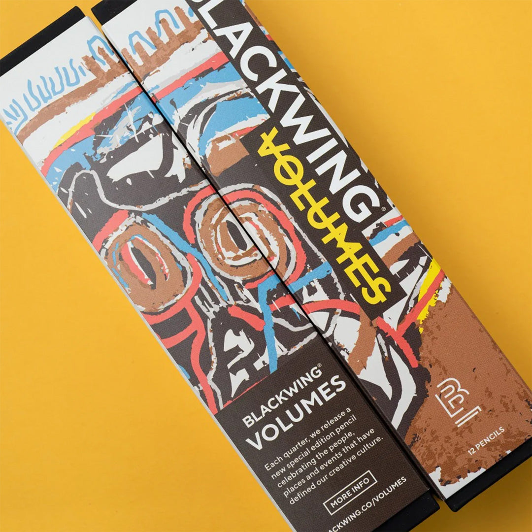 Front of Box. Special Edition Blackwing Pencil Set Volume 57 is a tribute to the boundary pushing NY artist Jean-Michel Basquiat. Each pencil features elements of his street style artwork and recognisable crown icon. The pencil has Blackwing's soft graphite lead, perfect for sketching, and a black replaceable eraser tip.